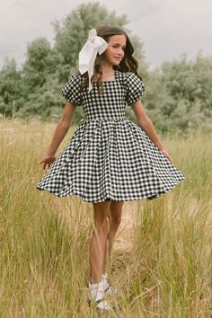 The perfect fall girl's dress has arrived! Introducing our Mini Cupcake Dress in Black Gingham! Featuring short puff sleeves, a darling functional bow, 100% cotton fabric and a knee-length fit. And did we mention the twirl-worthy skirt?! This dress is lovely for family matching, weddings and everyday wear! Kids Dresses For Weddings, Kids Cotton Frocks Design, Ideas For Babysitting, Cotton Frocks For Kids, Girls Fall Dresses, Spring Sewing, White Bridal Dresses, Mini Cupcake, Cupcake Dress