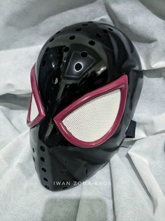 a black mask with red accents on it