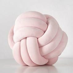 a large pink ball sitting on top of a white table