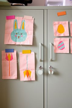 several pieces of paper are taped to the side of a gray locker with magnets on it