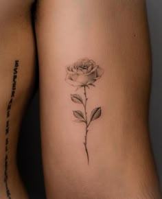 a rose tattoo on the back of a woman's thigh