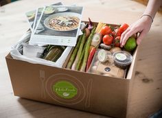 a box filled with lots of food on top of a wooden table