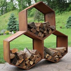 a stack of firewood stacked on top of each other in the middle of a park