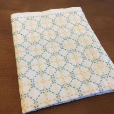 a close up of a cloth on a wooden table with wood flooring in the background