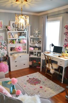 a living room filled with furniture and lots of pink flowers on the wall next to a window