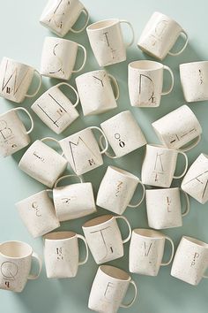 coffee mugs with the word love written on them are arranged in an arrangement to form a heart