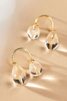 These earrings by AB Ellie offer asymmetrical glass teardrops suspended by a gold half-circle. | Asymmetrical Glass Drop Earrings by AB Ellie in Gold, Women's, Gold/Glass/Sterling Silver at Anthropologie Ab Ellie, Glass Drop Earrings, Half Circle, Gold Glass, Glass Earrings, Anthropologie, Paradise, Drop Earrings, My Style