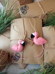 two pink flamingos are tied to brown packages