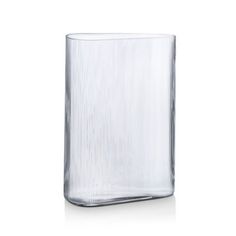 a clear glass vase sitting on top of a white table