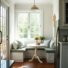 A bright and cozy kitchen corner featuring a small breakfast nook by a large window, with cushioned seating, a round table, and sunlight streaming in, offering a perfect spot to start the day. Small Breakfast Room, Breakfast Nook Kitchen, Cozy Kitchen Nook, Tea Corner, Nook Kitchen, Cottage Home Interior, Cozy Breakfast, Cozy Breakfast Nook, Improve Indoor Air Quality