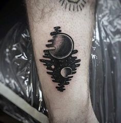 a man's leg with a black and white tattoo on it