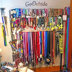 there are many different colored skis hanging on the wall