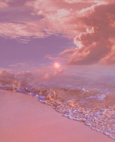 the sun is setting over the ocean with waves coming in to shore and pink clouds