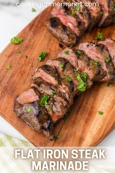 the steak is sliced up and ready to be eaten on the cutting board with parsley