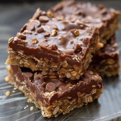 two pieces of chocolate peanut butter granola bars stacked on top of each other