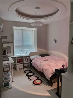 a bedroom with a bed, desk and shelves in the corner near a window that has blinds on it