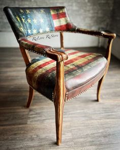 an american flag upholstered leather chair in a room with wood floors and brick walls