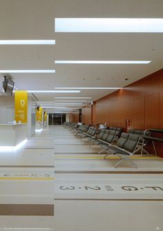 an empty waiting area with chairs and yellow signs