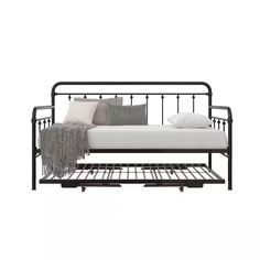 a metal daybed with white sheets and pillows on the bed frame, sitting against a white background