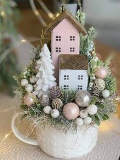 a white cup filled with christmas decorations on top of a table