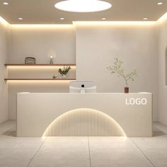 the front desk of a modern office with white walls and flooring is illuminated by recessed lighting