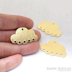 someone is holding some tiny gold clouds in their hand