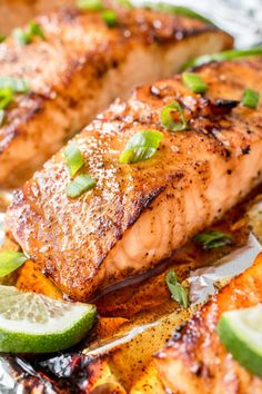 grilled salmon and vegetables on foil with limes