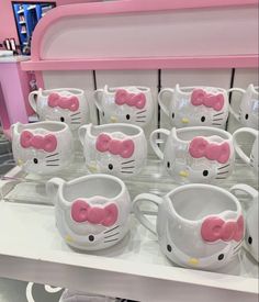 hello kitty mugs are on display in a store