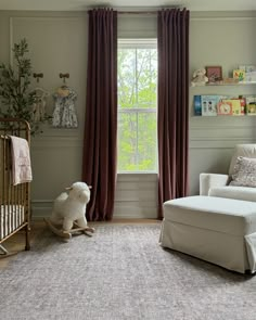 a baby's room with a crib, rocking horse and window in the corner