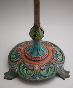 an ornately painted tortoise with a wooden stick sticking out of it