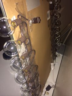 a bunch of glasses are hanging on the wall