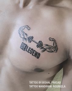 a man with a tattoo on his chest holding a barbell and the word belgeid