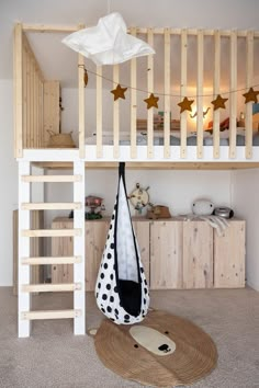 there is a bunk bed with a bag on the floor and stars hanging from the ceiling