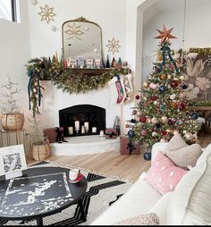 a living room decorated for christmas with a fireplace and tree in the corner, surrounded by holiday decorations