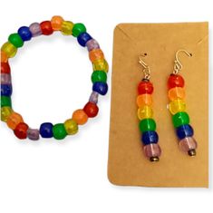 a pair of colorful beaded earrings next to a brown paper with a clipboard on it