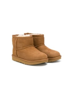 chestnut brown suede pull-on style tonal stitching round toe ankle-length shearling lining flat rubber sole Kids Ugg Boots, Chestnut Uggs, Ugg Kids, Kids Uggs, Sheepskin Boots, Sophia Webster, Chestnut Brown, Stella Mccartney Kids, Brown Leather Boots