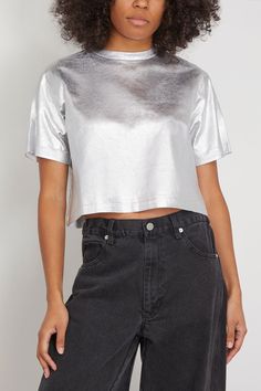 The Simkhai Label Tee in Silver Foil is a twist on a classic. This t-shirt features a cropped, boxy silhouette in a bold metallic silver. Wear yours with high rise jeans and heels. Fits true to size, take your normal size T-shirt Cropped length Boxy silhouette Metallic threading Drop shoulders 93% cotton, 7% elastane with 98% cotton, 2% elastane Celeste is wearing a size XS Bust: 35" Waist: 25.5" Hips: 33" Height: 5’10” Silver Crop Top, Embroidery Coat, Diy Fashion Projects, American Fashion Designers, Suede Mini Skirt, Tank Top Designs, Silver Foil, High Rise Jeans