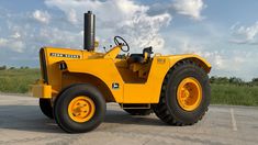 a large yellow tractor parked in a parking lot