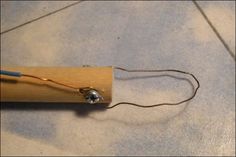 a piece of wood that has been hooked up to an electrical device with wires attached