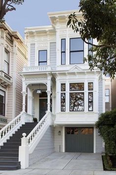 a large white house with stairs leading up to it