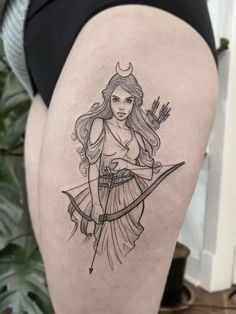 a woman with a bow and arrow tattoo on her thigh