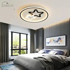 a bed room with a neatly made bed and a star ceiling light