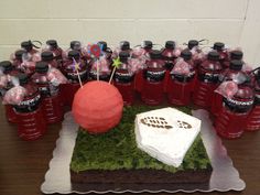 there is a cake and many water bottles on the table