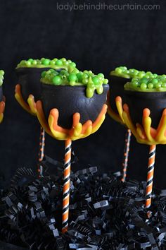 three halloween candy cups with candies in them