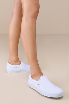 You'll reach for the Vans Classic True White Slip-On Sneakers time and time again when you want to create casually cool looks! These timeless sneakers have a sturdy canvas construction that creates a sleek silhouette with a rounded toe upper, elastic gussets at the sides, and a low-cut, padded collar. The effortless slip-on design makes these shoes essential when you have places to go and things to do! Logo tag at the outstep and heel. 1" rubber sole. Lightly cushioned insole. Rubber sole has no White Slip On Outfit, Slip On Outfit, White Slip On Sneakers, Casual Shoes Women Sneakers, White Slip On Shoes, White Canvas Shoes, Ivory Shoes, White Slip, Rubber Shoes