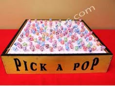 a wooden box with flowers on it and the words pick a pop written in black