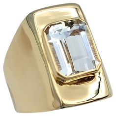 Ring Size: 6 This unique solitaire goshenite beryl ring set in 14 karat yellow gold exudes understated elegance and sophistication. The centerpiece of this exquisite ring is the goshenite beryl, a colorless gemstone prized for its clarity and brilliance. Set atop a lustrous band of 14 karat yellow gold, the goshenite beryl takes center stage, captivating the eye with its pristine beauty and natural radiance. The minimalist modern design of the ring allows the goshenite beryl to shine, making it the focal point of attention. The sleek and reflective band enhances the gemstone's allure, creating a harmonious balance between simplicity and refinement. With its timeless design and versatile appeal, it is the perfect addition to any fine jewelry collection. This piece is in very good estate con Beryl Ring, Money Fashion, Fine Jewelry Collection, Understated Elegance, Dream Board, Minimalist Modern, Center Stage, Cocktail Ring, Cocktail Rings