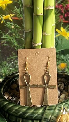 Ankh dangle earrings in rustic gold color Symbolic Metal Dangle Earrings, Gold Dangle Earrings With Fish Hook, Nickel-free Ankh Earrings As Gift, Nickel Free Ankh Earrings For Gift, Brass Jewelry With Fish Hook For Gift, Bronze Ankh Necklace, Bronze Ankh Shaped Metal Jewelry, Bronze Ankh Metal Jewelry, Ankh Earrings Jewelry As A Gift