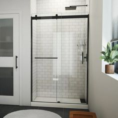 a bathroom with a shower, toilet and rug