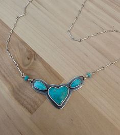 "Small statement.  This is created with 925 sterling silver.  The focal stone is a gorgeous Campitos turquoise heart.  The accent turquoise are Kingman.  A simple setting.  Keeping the focal on the awesome stones.  A small but strong chain has been added.  I have cold connected the pendant and clasp, using beautiful Pilot Mountain rondels.  Giving the one-of-a-kind personal touch.  A gorgeous everyday wear.  For years to come.  18\" length. See pictures for size reference.  Ready to ship." One Of A Kind Sterling Silver Heart Necklace, One Of A Kind Heart-shaped Sterling Silver Necklace, One Of A Kind Turquoise Heart Jewelry, One-of-a-kind Turquoise Heart Jewelry, Turquoise Sterling Silver Heart Pendant Necklace, Sterling Silver Turquoise Necklace With Heart Charm, Turquoise Heart Pendant Necklace In Sterling Silver, Heart-shaped Sterling Silver Turquoise Necklace, Turquoise Cross Necklace